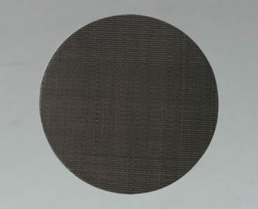 A piece of round filter disc made of black wire cloth.